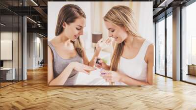 Beautiful Young Girl does Manicure to Friend. Wall mural