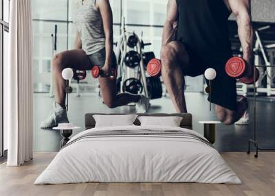 Close up. Man and Woman Training in Fitness Club. Wall mural