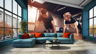 Father and son in the gym. Father and son spend time together and lead a healthy lifestyle. Wall mural