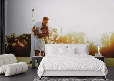 Father Playing Golf with Little Daughter on Field. Wall mural