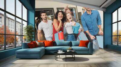 Sale in black Friday. The company of young people are engaged in shopping on a black Friday. Wall mural