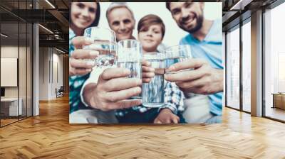 Smiling Family Drinking Water in Glasses at Home. Wall mural