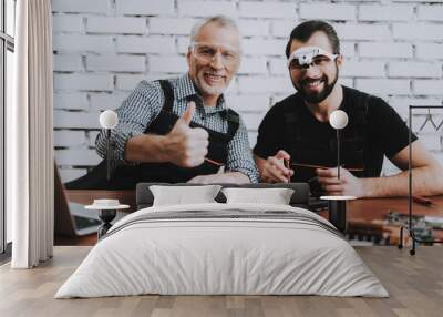 Two Men Repairing Mobile Phone in Modern Workshop. Wall mural