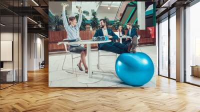 Workers exercising stretching arms in office. Wall mural