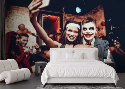 Young Couple in Halloween Costumes taking Selfie Wall mural