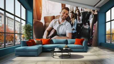 Young Handsome Man Relaxing in Seat of Tour Bus Wall mural