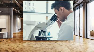 Young Scientist using Microscope in Laboratory Wall mural