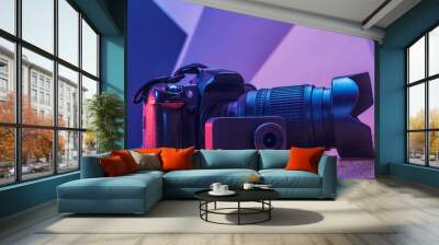 Set of equipment for photography and video filming. Photo camera with lens, action camera and usb flash drive on a wooden table in a studio with creative light. Wall mural