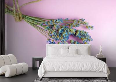 Decorative dry lavender bouquet on pink background. Close up. Wall mural