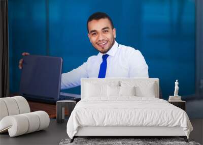 Handsome young business man working on laptop at cafe, cropped portrait . Coffee break, business concept Wall mural