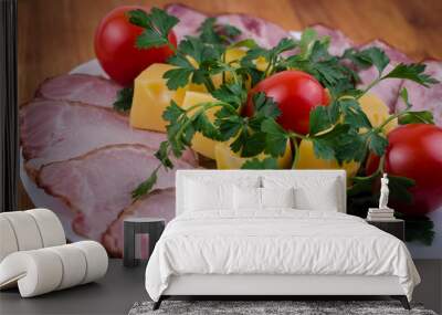 Homemade meat and sausage with cheese, tomatoes and herbs on a white plate Wall mural