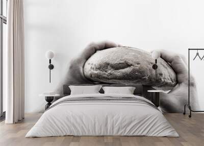 Round bread in male hands on a white background, the value of bread and hunger Wall mural