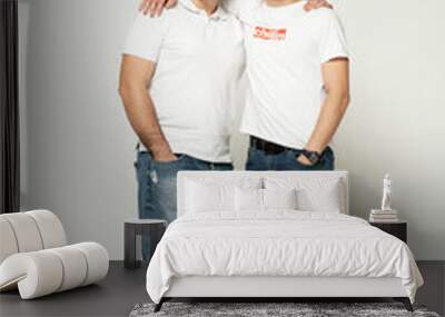 two brothers on a white background. older brother with younger. portrait of two friends. Wall mural