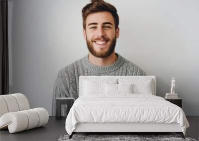 Young handsome man with beard wearing casual sweater. Attractive male with happy and cool smile on his face. Isolated on white background. Photogenic adult man with stylish and confident look. Wall mural