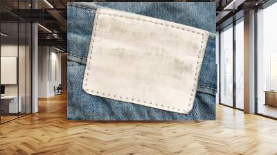 Empty worn leather patch on blue jeans. Empty space for writing. Blank leather jeans label Wall mural