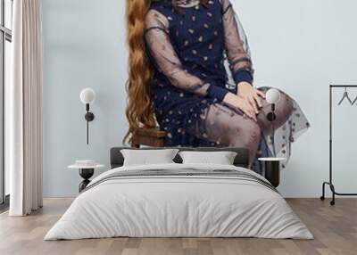 teenage girl with long red hair in a dress. photo shoot in the studio Wall mural