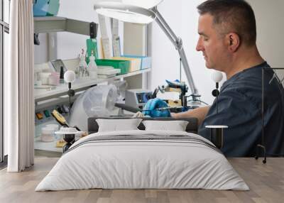 Dental technician working with tooth denture Wall mural