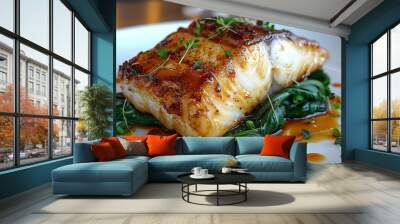 A medium-full portion of black cod served on a white plate, resting on a bed of vibrant green pak choi. Fish well presented with a golden-brown coating. Wall mural