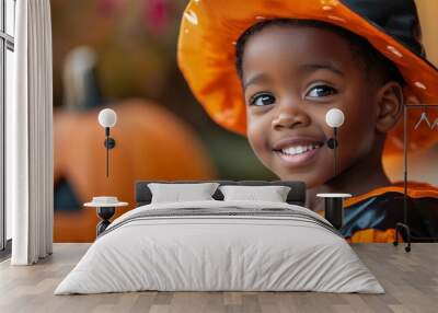 A vibrant portrait of a smiling little black boy wearing a creative halloween costume. The little boy has a happy and infectious expression, full of energy and festive spirit. Wall mural