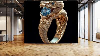 Close-up of a luxurious gold ring for men in the shape of a snake. Gold ring with a snake holding a blue gemstone in its mouth. Wall mural