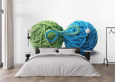 Two green and blue cotton thread balls tied in bow isolated on white background.  Different color green and blue thread balls.  Wall mural