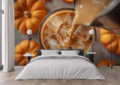 Cold  latte coffee drink with ice and orange pumpkin juice Wall mural