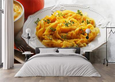 Tagliatelle pasta with pumpkin cream sauce over white background Wall mural