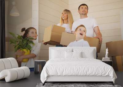 Happy family with two children at new home. Mother father and child in new house Wall mural