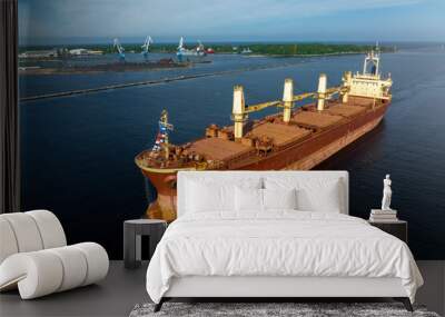 Large empty cargo ship in the sea during sunny summer day Wall mural