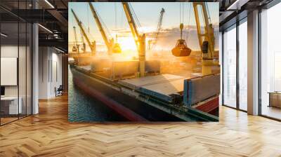 Large international transportation vessel in the port, loading grain during sunrise for export in the sea waters. Wall mural