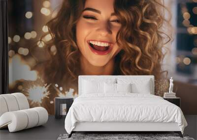 blissful curly woman with sparklers enjoying christmas time. indoor photo of laughing pretty girl with ben Wall mural