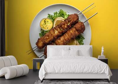 fried kebab on plate and on a table on yellow background Wall mural