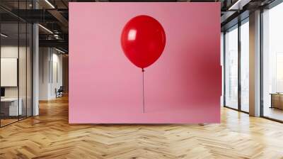 Vibrant Red Balloon Against a Soft Pink Background Wall mural