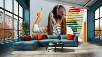 Child using an abacus. Wall mural