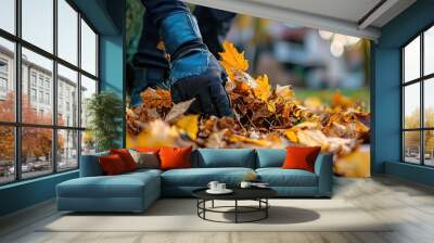 a man cleans autumn leaves near the house. Selective focus Wall mural