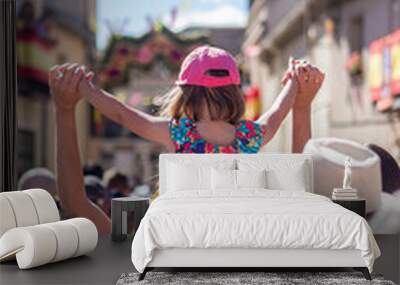 Girl on shoulders in a street of Bernardos Wall mural