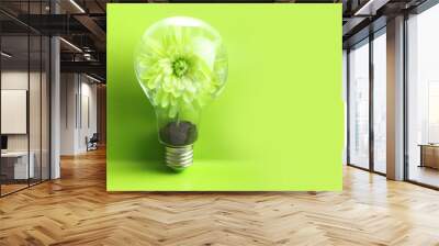 Green plant inside light bulb. Wall mural