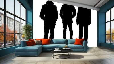 Vector silhouettes of three young people in warm winter clothes, stand tall, straight two men and one woman isolated on a white background Wall mural