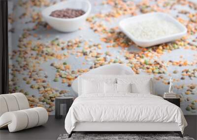 Different types of cereal grains groats in white ceramic bowls. Food background. Top view. Wall mural