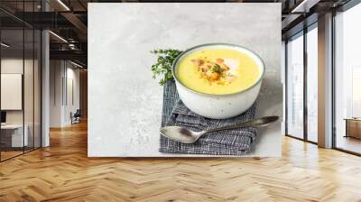 Thick milky chowder soup with seafood served with sour cream, thyme and pepper. Light grey stone background.  Wall mural