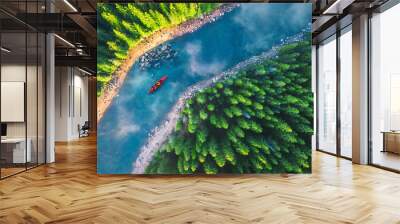 Aerial view of rafting boat or canoe in mountain river and forest. Recreation and camping Wall mural