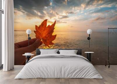 Autumn leaf and sunrise over the sea Wall mural