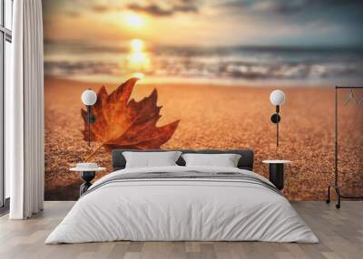 Autumn leaf on the sand. Beautiful cloudscape over the sea, sunrise shot
 Wall mural