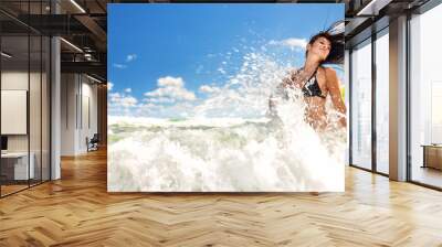 Beautiful girl splashing in the ocean Wall mural