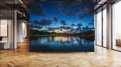 Beautiful sunset over the lake near the golf course in a tropica Wall mural