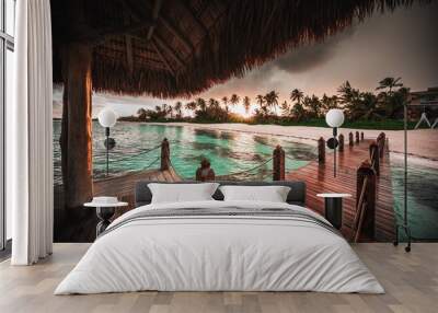 Beautiful view toward tropical beach from wooden water villa Wall mural