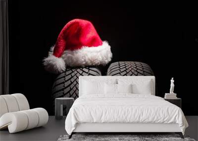 Car tire service and christmas hat on black background with copy space for text Wall mural