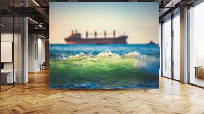 Sailing cargo ship and waves at sunrise. Transportation. Logistics. Shipping. Wall mural