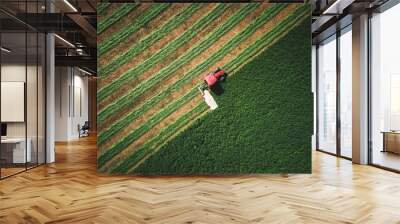 tractor mowing green field Wall mural