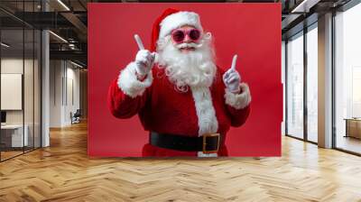 A man dressed as Santa Claus pointing at the camera with his finger up Wall mural